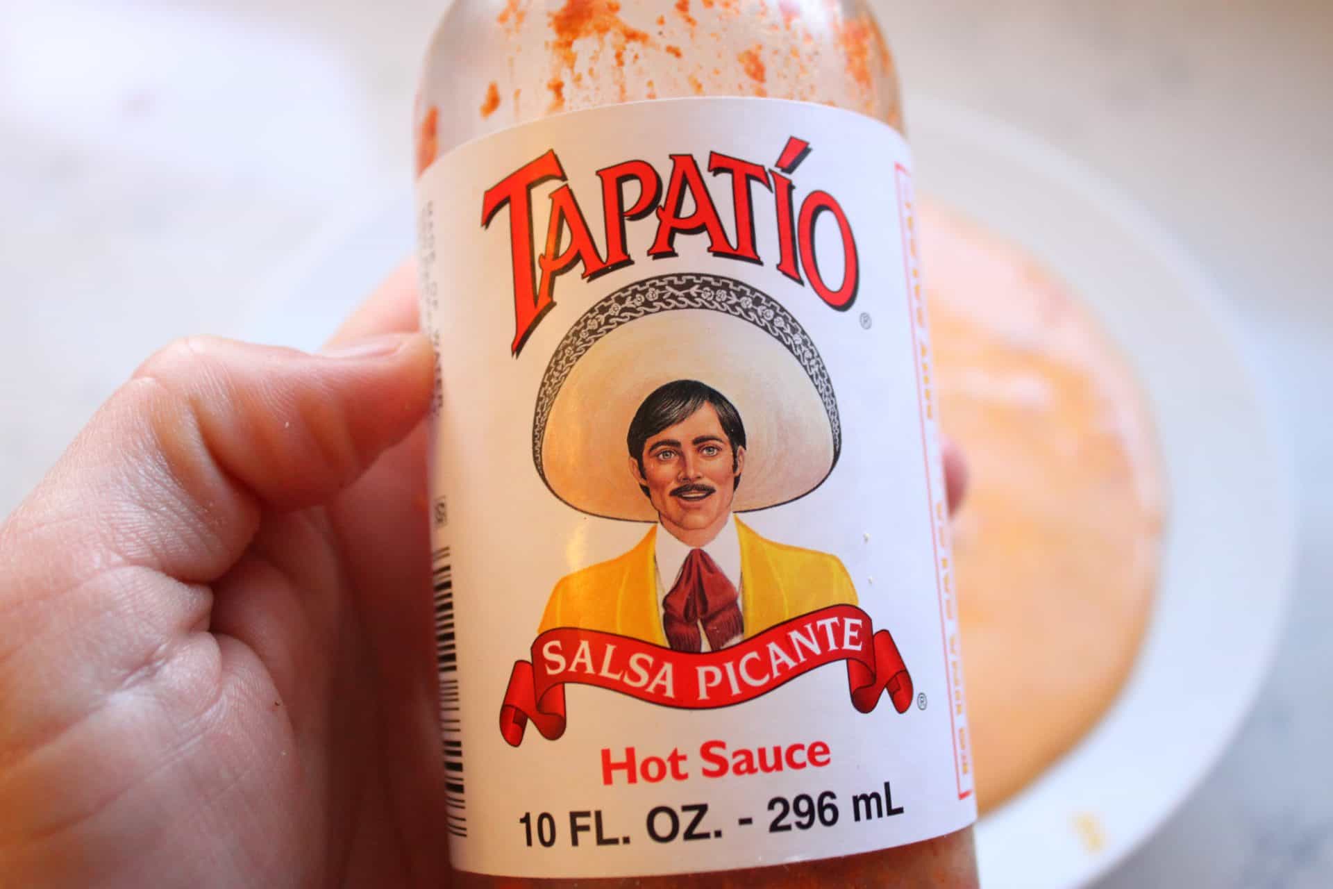 Holding a Bottle of Topatio