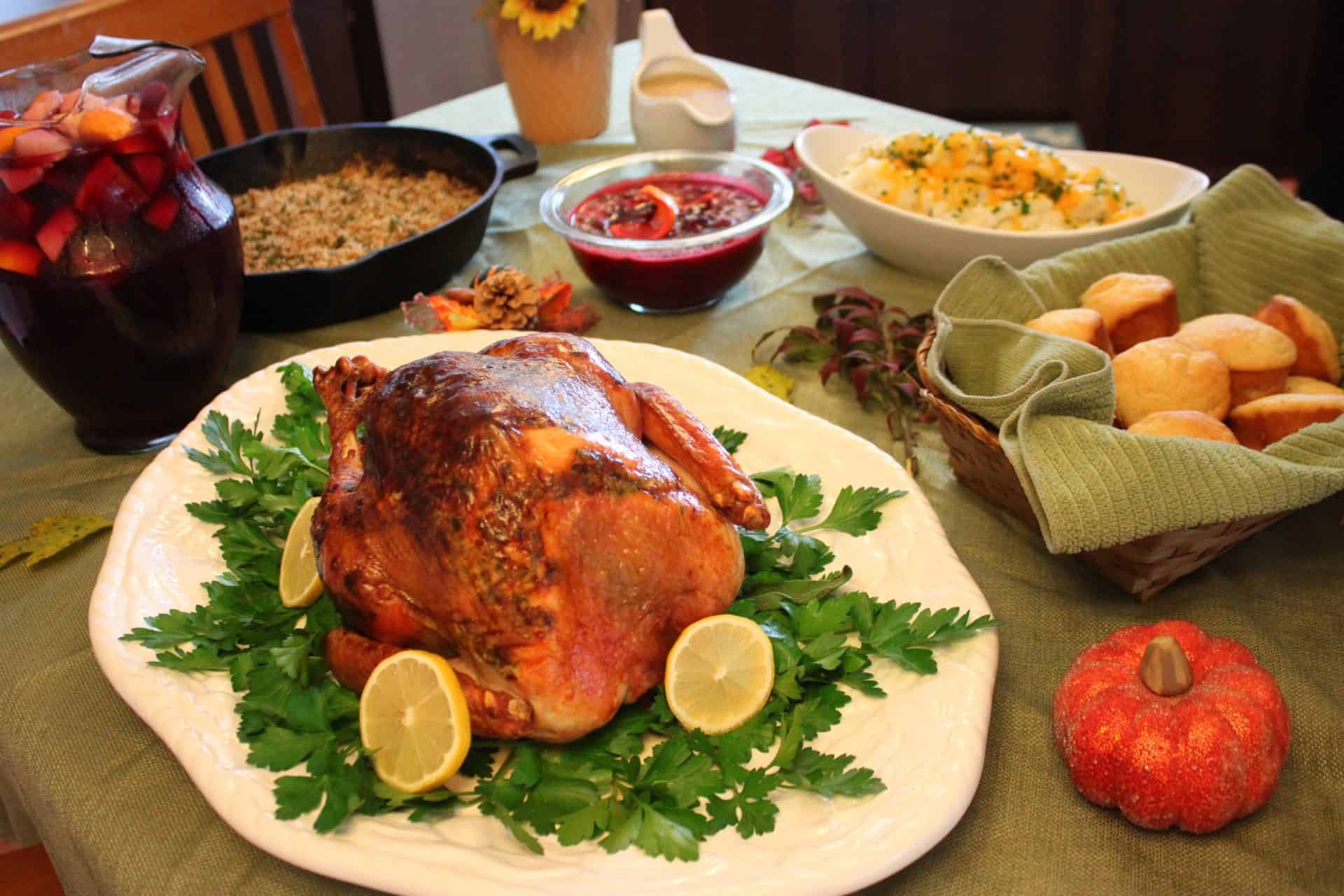 Foolproof 3-Step Tuscan-Style Roasted Turkey for the Holidays 17 Tuscan-style roasted turkey surrounded by side dishes like salad, cranberry sauce, and bread, a holiday meal to remember.