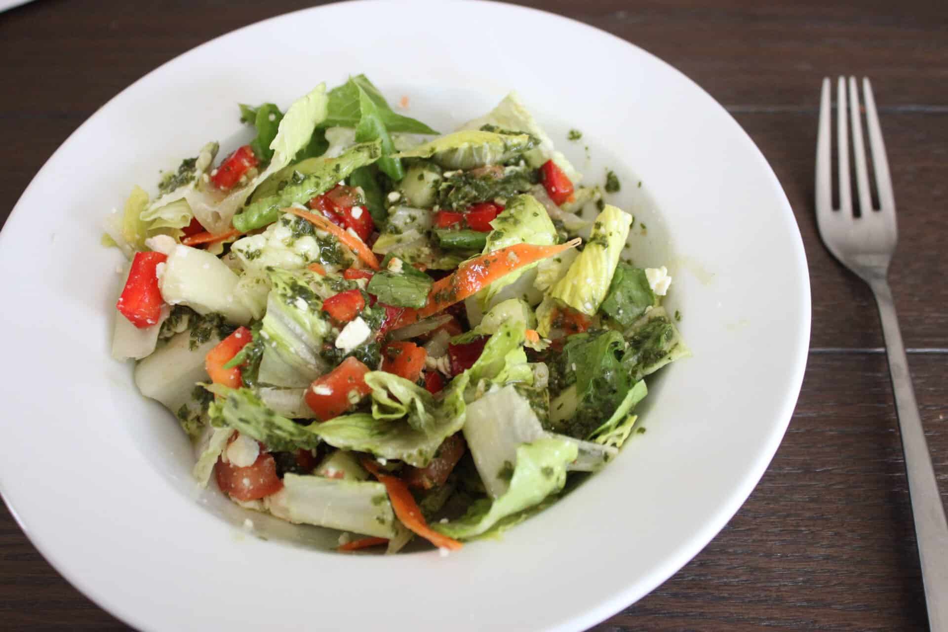 Vegetable Salad with Basil Dressing in a White Bowl