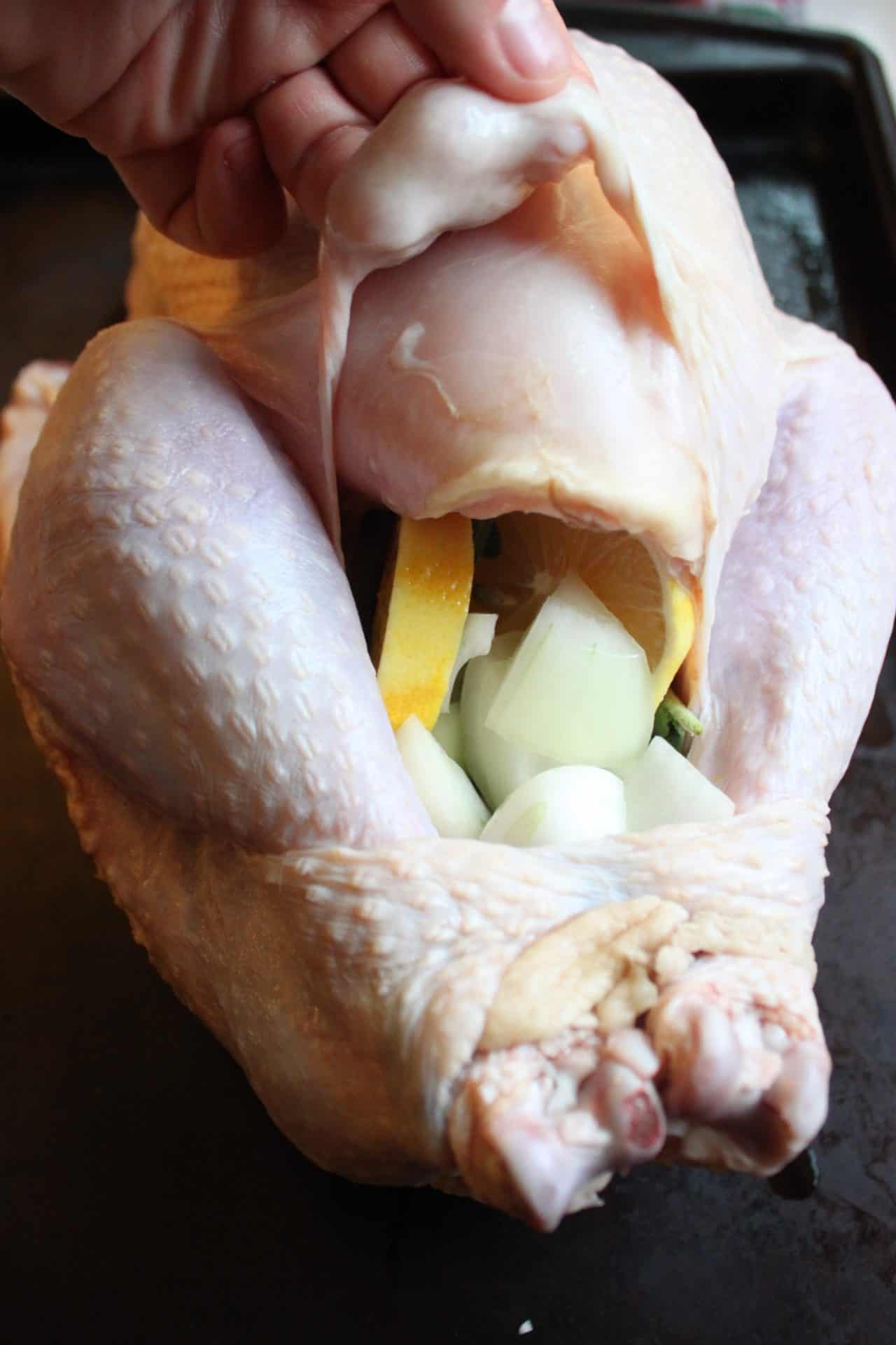 Foolproof 3-Step Tuscan-Style Roasted Turkey for the Holidays 7 Hands gently separating skin from the meat of Tuscan-style roasted turkey to add flavorful herbed butter mixture.