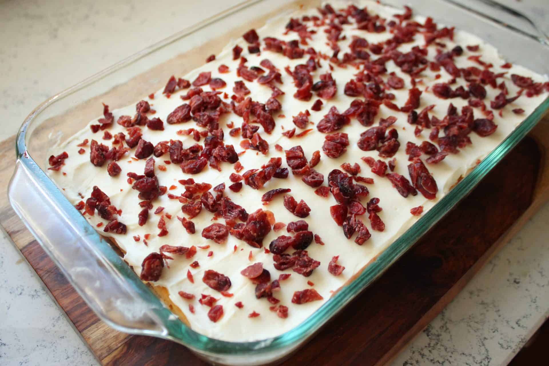 Easy Recipe for Copycat Starbucks White Chocolate Cranberry Bliss Bars 4 Dried cranberries sprinkled on cream cheese frosting, adding a tart bite to the Starbucks white chocolate cranberry bliss bars.